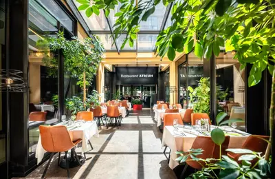 a restaurant with tables and chairs in a building at Grand Majestic Hotel Prague in Prague