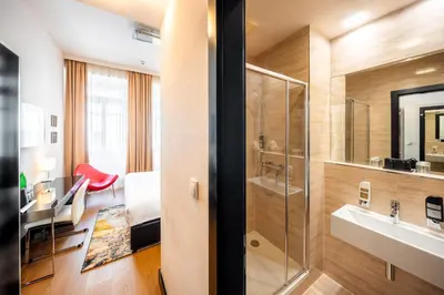 a bathroom with a sink and a shower at Grand Majestic Hotel Prague in Prague