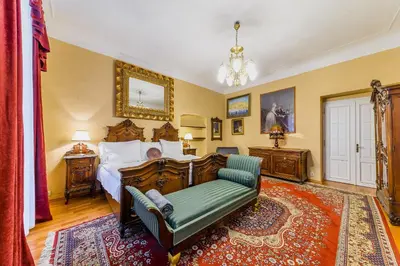 a bedroom with a bed and a couch and a chair at Residence Seven Angels in Prague