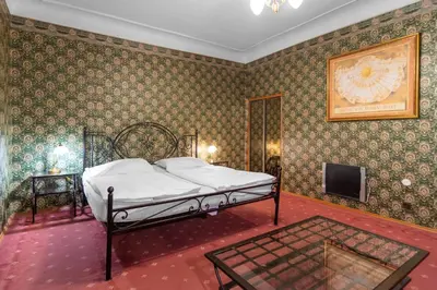 a bedroom with a bed and a tv in it at Residence Seven Angels in Prague