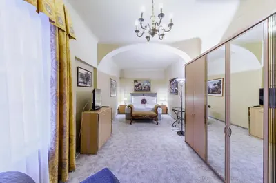 a hallway with a room with a bed and a chandelier at Residence Seven Angels in Prague