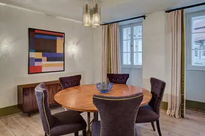a dining room with a wooden table and chairs at Augustine, a Luxury Collection Hotel, Prague in Prague