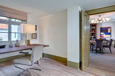 a home office with a desk and a chair at Augustine, a Luxury Collection Hotel, Prague in Prague