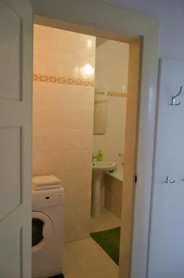 a bathroom with a washing machine and a sink at Pravouhla in Prague