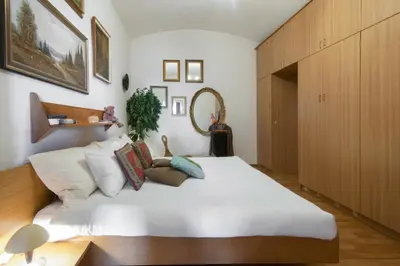 a bedroom with a large white bed with pillows at Victoria Design Stays - Apartment Rehorova in Prague