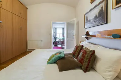 a bedroom with a white bed with pillows on it at Victoria Design Stays - Apartment Rehorova in Prague
