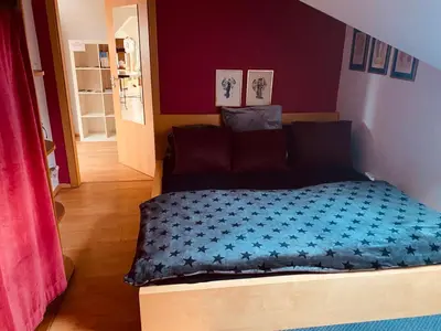 a bedroom with a bed with a blue comforter at Apartment Neratovice in Neratovice
