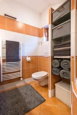 a bathroom with a toilet and some towels at Apartment Neratovice in Neratovice