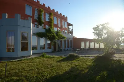 a building with a grass yard next to a building at Penzion Folbr in Dlouhá Lhota