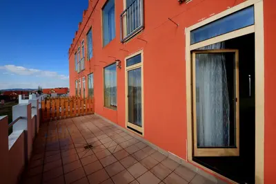 an orange building with a walkway in front of it at Penzion Folbr in Dlouhá Lhota