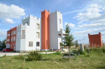 a building with orange and white in a field at Penzion Folbr in Dlouhá Lhota