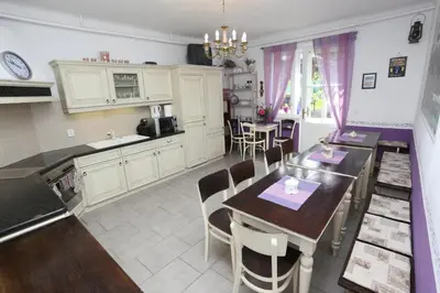 a kitchen and dining room with a table and chairs at Vila Sazava in Sázava