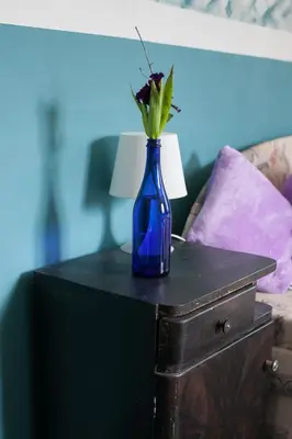 a blue vase with flowers on top of a table at Vila Sazava in Sázava