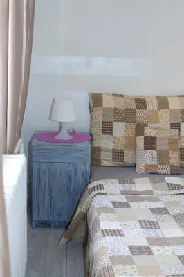 a bedroom with a bed and a lamp on a table at Vila Sazava in Sázava