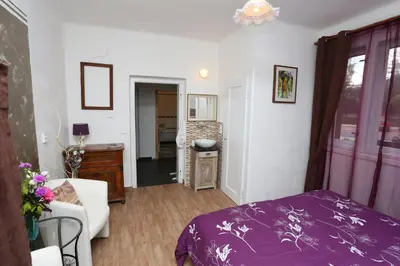 a bedroom with a purple bed and a living room at Vila Sazava in Sázava
