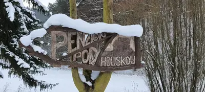 a sign with snow on top of it at Penzion Pod Houskou in Blatce