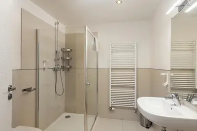 a bathroom with a shower and a sink at Salvatore Prague Rooms in Prague