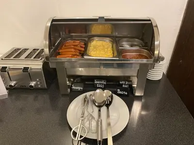 a food machine with a plate of food on a counter at Red & Blue Design Hotel Prague in Prague