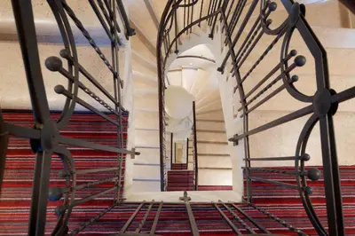 a view of a hallway with stairs and a mirror at Red & Blue Design Hotel Prague in Prague