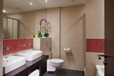 a bathroom with two sinks and a toilet and a shower at Red & Blue Design Hotel Prague in Prague