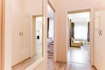 a hallway with a mirror and a living room at Apartment Masná 21 in Prague