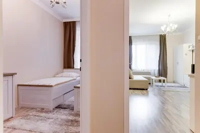 a bedroom with a bed and a living room at Apartment Masná 21 in Prague