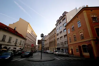 a city street with parked cars and buildings at Apartment Masná 21 in Prague