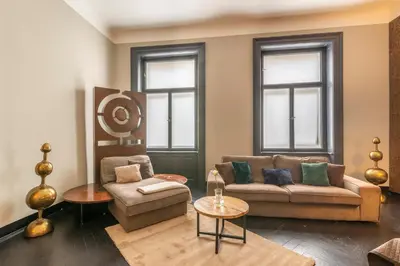 a living room with a couch and a chair at Masná - Old Town Residence in Prague