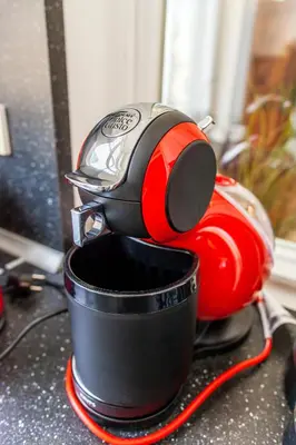 a red and black toaster sitting next to a cup at Masná - Old Town Residence in Prague