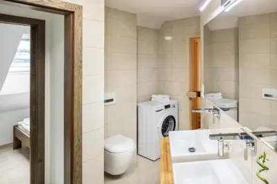 a bathroom with a washing machine and a sink at Templova Old Town Apartment in Prague