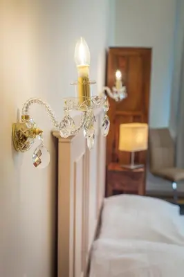 a chandelier hanging from a wall in a bedroom at Templova Old Town Apartment in Prague