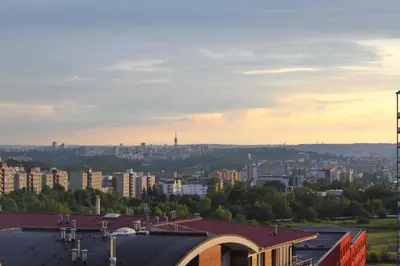 a view of a city with buildings in the distance at Sunny Two-story Apartment Kyje in Prague
