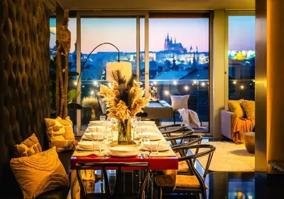 a dining table with chairs and a view of a city at Billionaires Boutique Residence & Premium Suites, Old Town in Prague