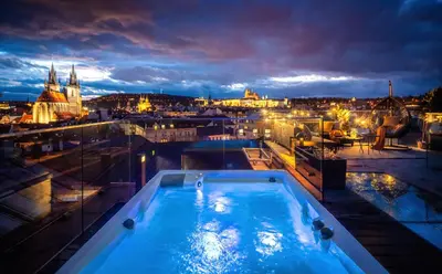 a hot tub on top of a building at night at Billionaires Boutique Residence & Premium Suites, Old Town in Prague