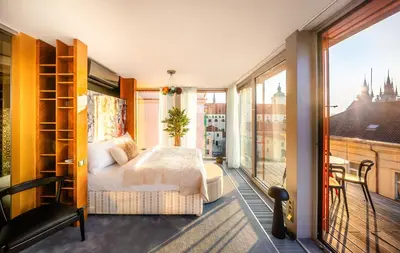 a bedroom with a bed and a large window at Billionaires Boutique Residence & Premium Suites, Old Town in Prague