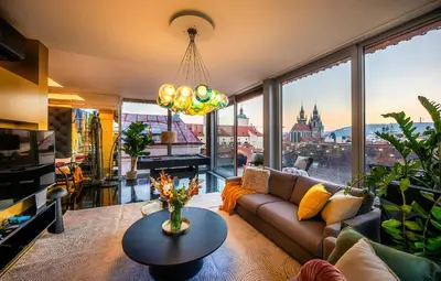 a living room with a couch and large windows at Billionaires Boutique Residence & Premium Suites, Old Town in Prague