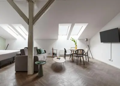 a living room with a couch and a table at Limehome Prague Halkova in Prague