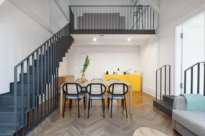 a dining room with a table and four chairs at Limehome Prague Halkova in Prague