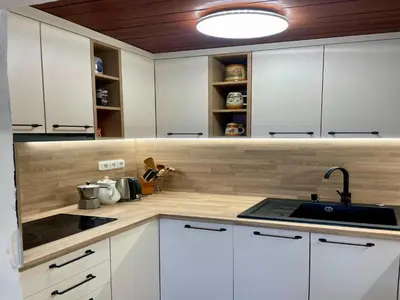 a kitchen with white cabinets and a sink at Outdoor Adventure & Relaxation in Svinařov
