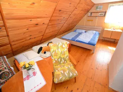 a room with a bed and a table and a chair at Outdoor Adventure & Relaxation in Svinařov