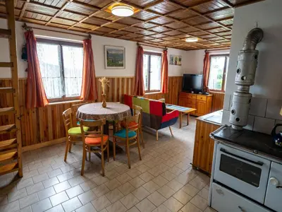 a kitchen and dining room with a table and chairs at Outdoor Adventure & Relaxation in Svinařov