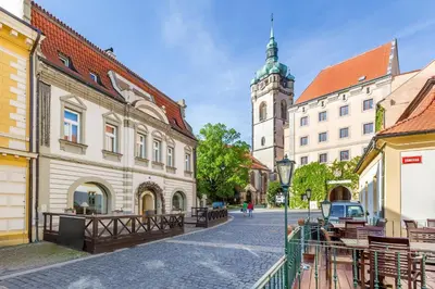 a street in a town with a clock tower at Hotel U Rytíře in Mělník