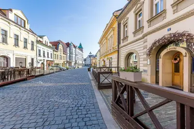 a cobblestone street in a city with buildings at Hotel U Rytíře in Mělník