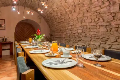 a long table in a restaurant with a stone wall at Hotel U Rytíře in Mělník