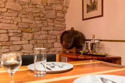 a table with plates and glasses on top of it at Hotel U Rytíře in Mělník