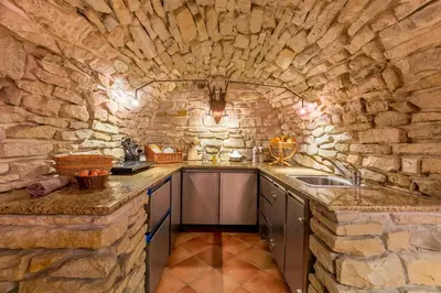 a stone kitchen with a sink and a counter at Hotel U Rytíře in Mělník