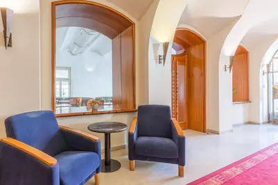 a hallway with two chairs and a table at Hotel U Rytíře in Mělník