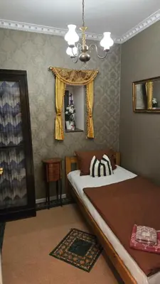 a bedroom with two beds and a chandelier at St. Terezie - Baroque Residence in Prague