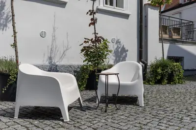 two white chairs and a table on a patio at St. Terezie - Baroque Residence in Prague