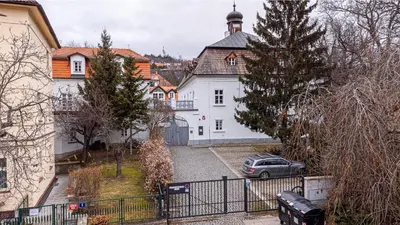 a car parked in front of a white building at St. Terezie - Baroque Residence in Prague